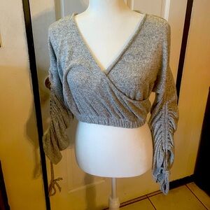 Grey or greyish blue cross crop with cinched tie long sleeve